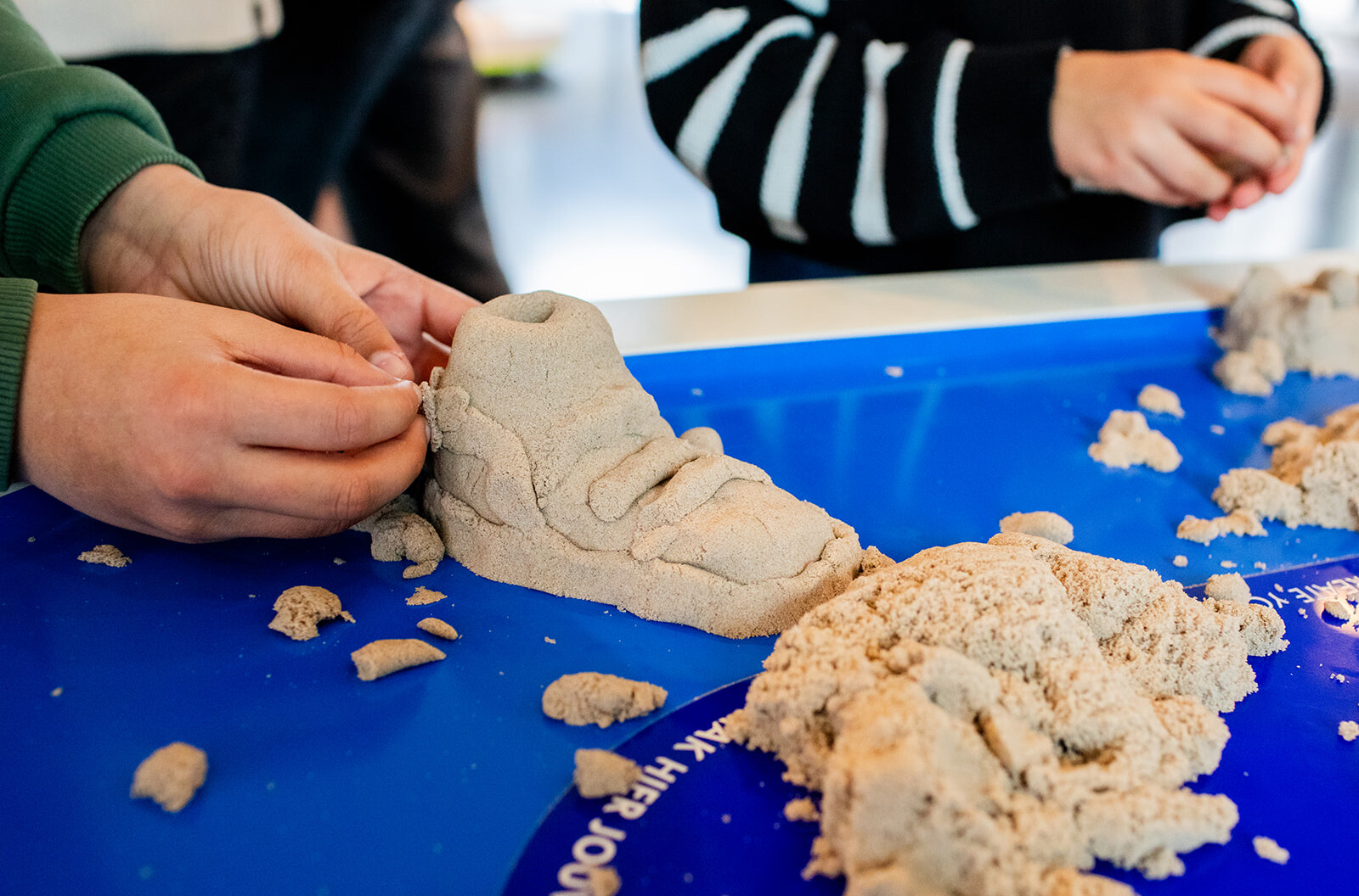 Een ontwerp voor een schoen vorm gegeven in zand.