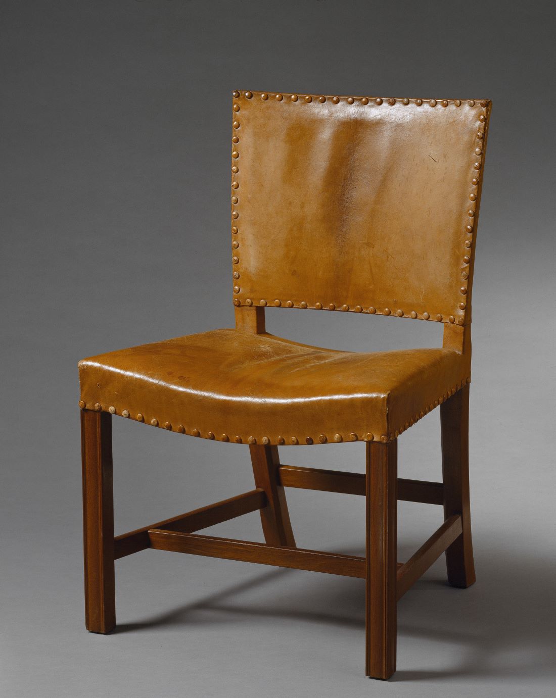 This is a picture of a chair. The chair is made of wood and leather. 